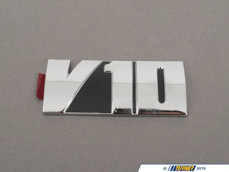 11617834686 - Genuine BMW V10 Emblem - S85 5.0L | Turner